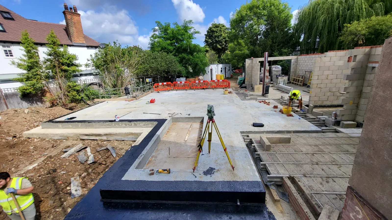 A construction site with a man working on it.